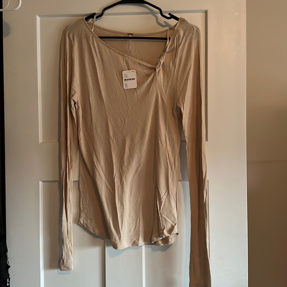 NWT Free People long sleeve shirt in tan with fun detail by neck on left side.